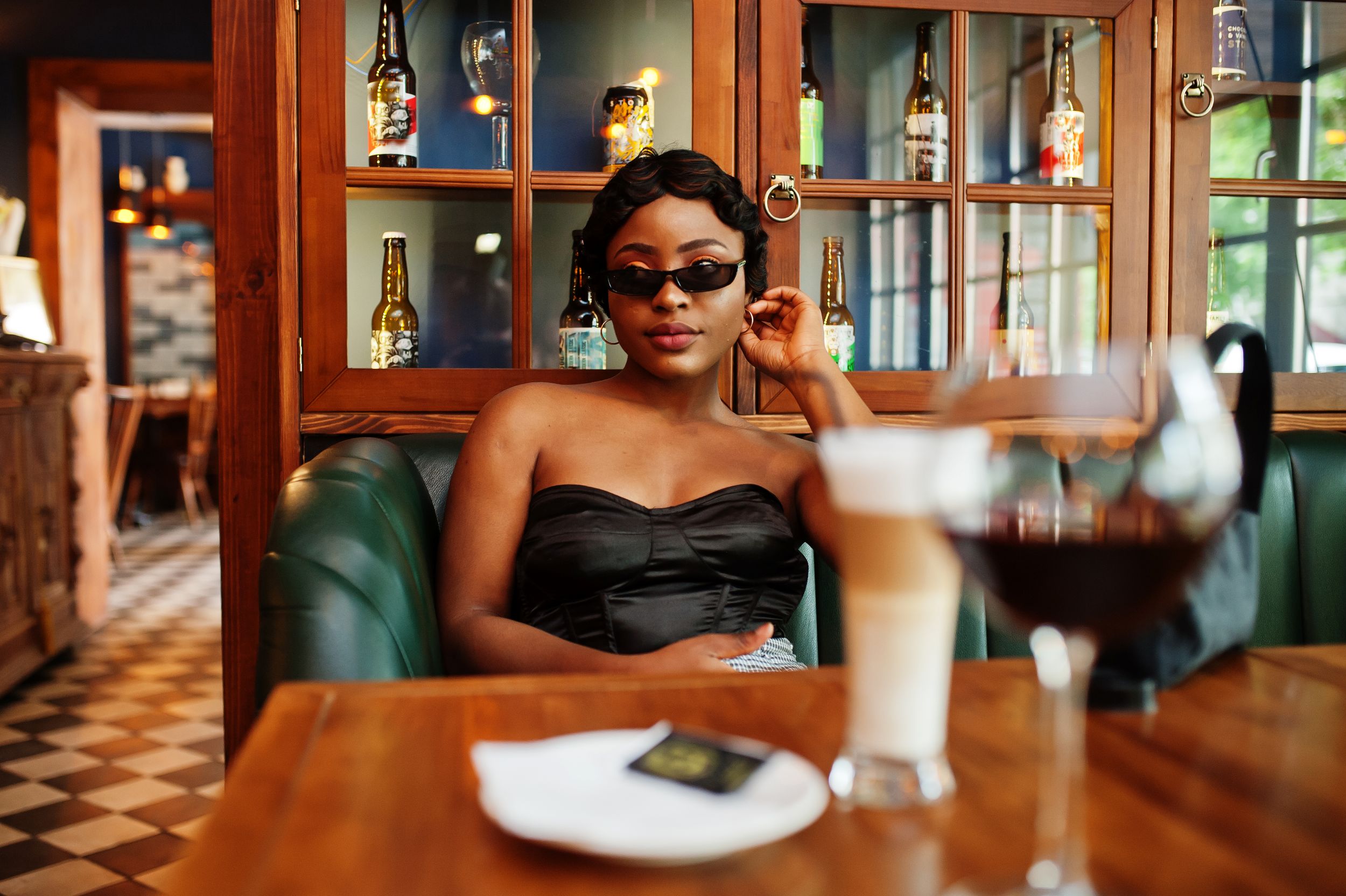 classy woman sitting at restaurant with glass of wine
