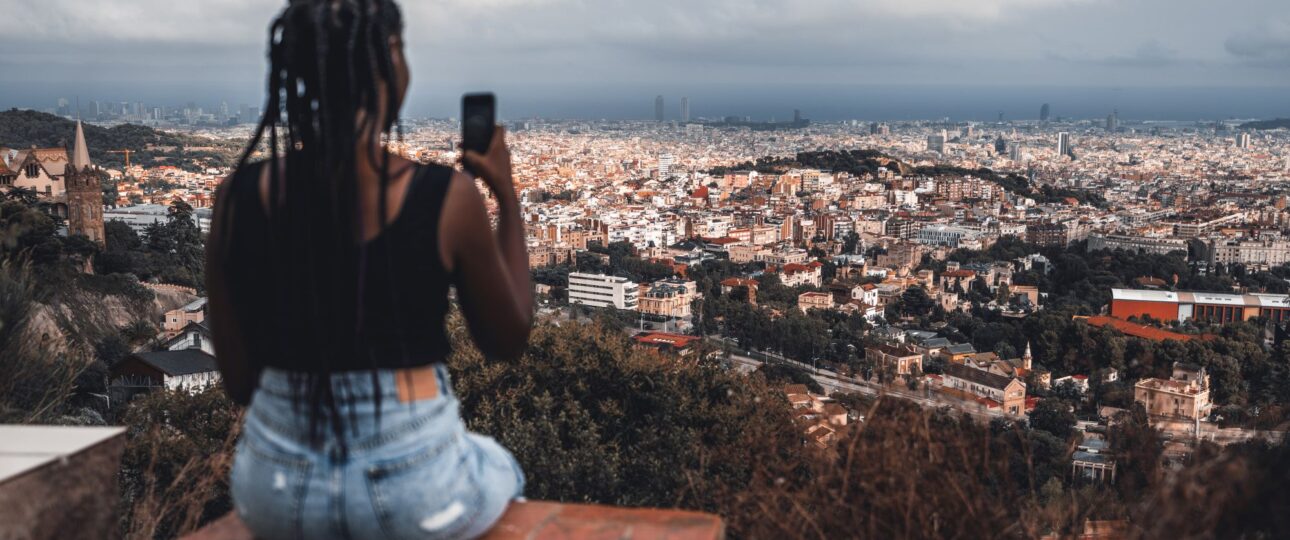 woman enjoying a cityscape from above and taking a photo