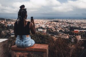 woman enjoying a cityscape from above and taking a photo