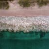 waves and sandy beach of Playa Flamingo in Costa Rica with an aerial perspective
