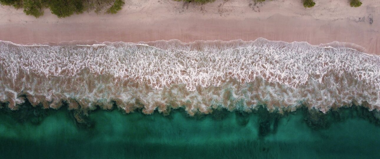 waves and sandy beach of Playa Flamingo in Costa Rica with an aerial perspective