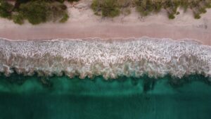 waves and sandy beach of Playa Flamingo in Costa Rica with an aerial perspective